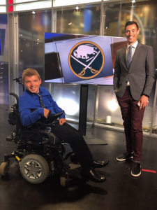 Dustyn posing next to Joe Buscaglia in the Channel 7 news studio.