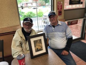 Steve and Ralph pose at a table where they met to reunite over coffee at a Tim Horton's.
