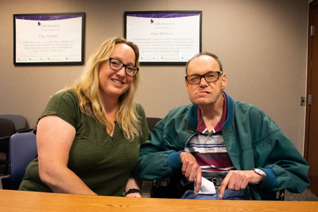 Care Coordinator Tami posing with Jerry at Jerry's day habilitation center.